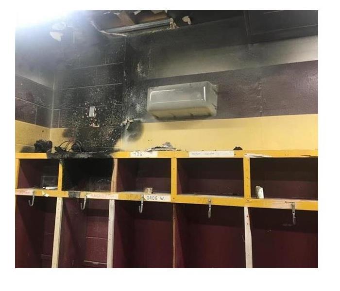 Damage shown in school locker room after a fire.