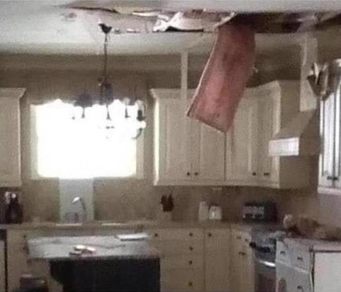 Kitchen with ceiling damage caused by storm.